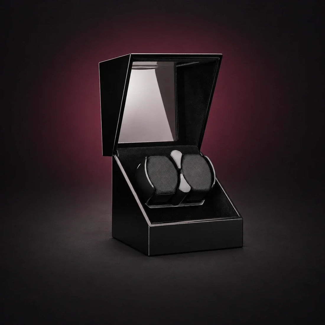 Studio black double-watch winder with its lid open and two cushions on a shared holder; digitally styled supplier photograph.