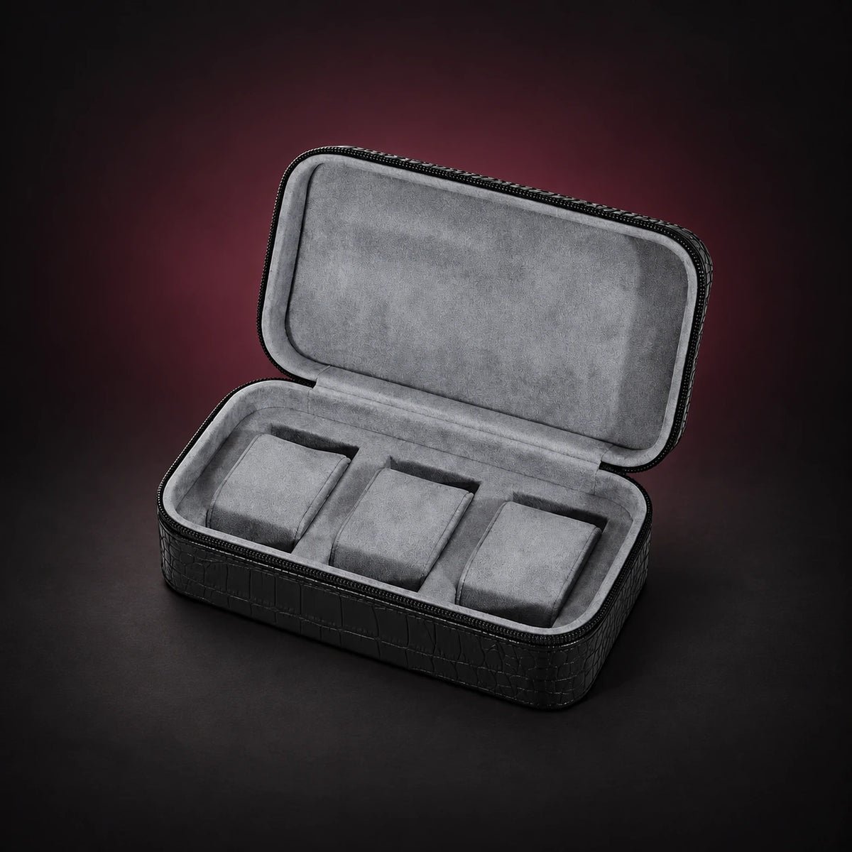 Voyage black croc-effect three-watch travel case, open to a gray padded interior with three individual cushions.