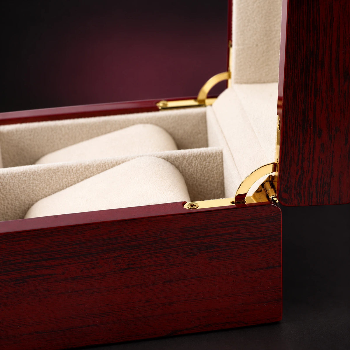 Close-up of the Heritage watch box red wood-grain finish, cream interior and gold-tone lid hinge.
