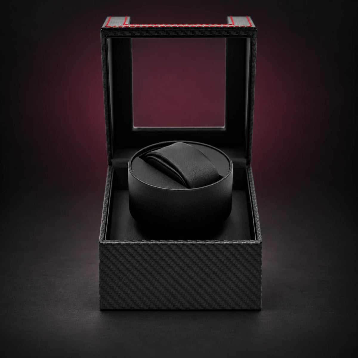 Solo black carbon-look single watch winder with its clear hinged lid open and one empty cushion.