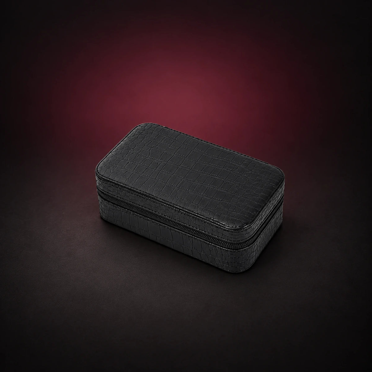 Voyage black croc-effect three-watch travel case shown closed with its zippered edge visible.